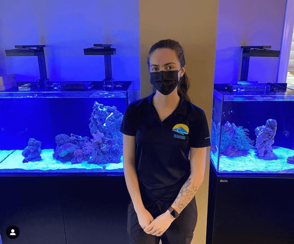 Berklee in front of Customer Aquarium After Cleaning