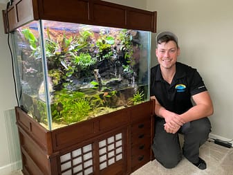 Owner In Front Of Recently Cleaned Vivarium