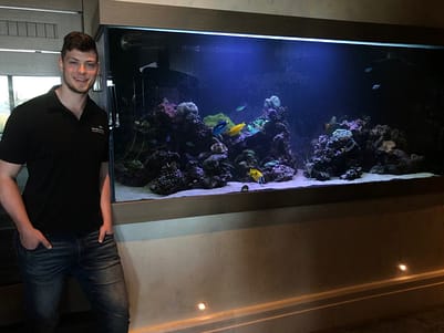 Owner In Front Of Cleaned Fish Tank